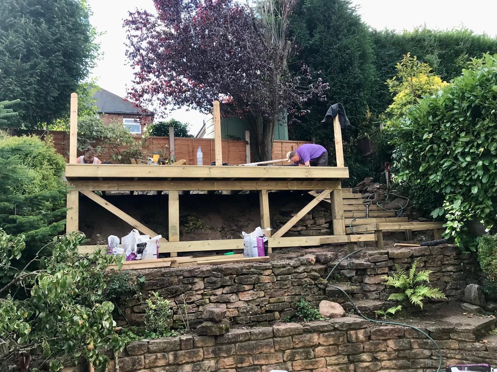 Terraced garden during construction — deck frame being built