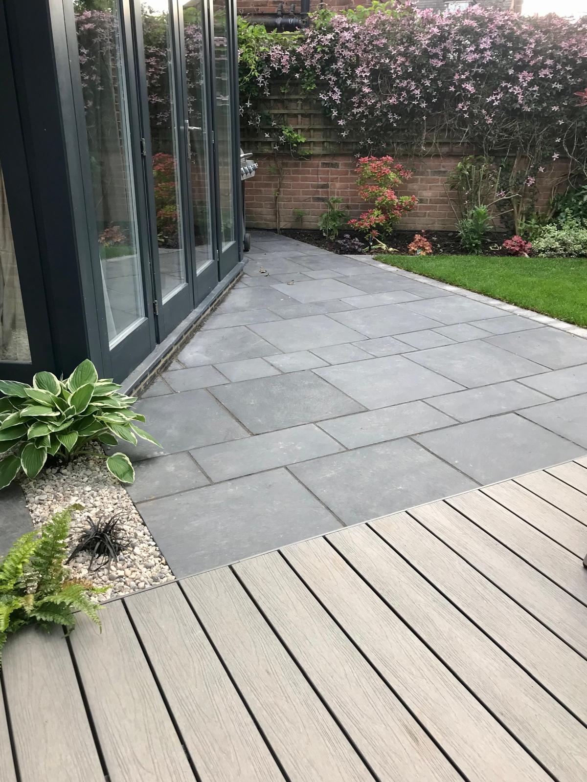 Garden after overhaul — grey porcelain patio, composite decking and fresh planting