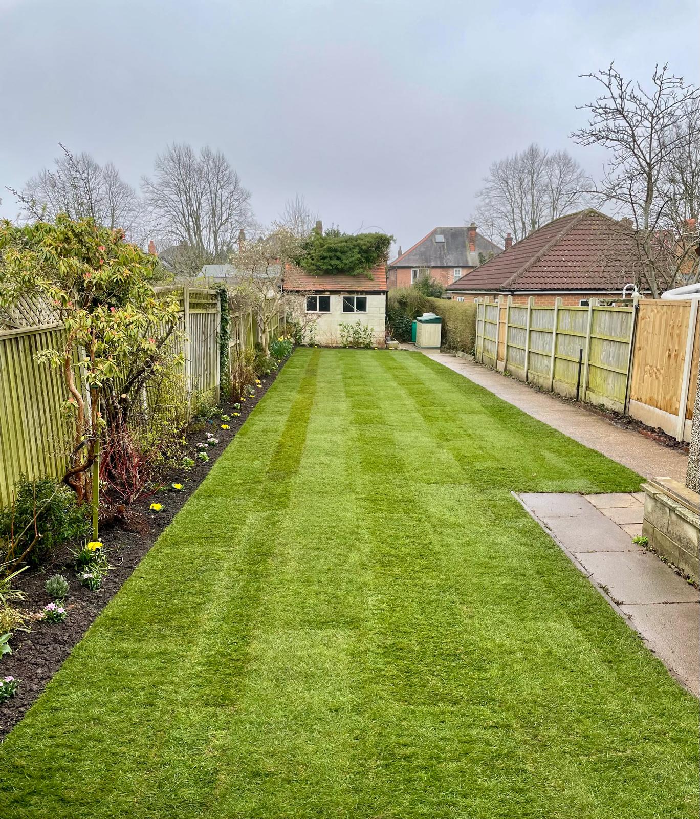 Striped lawn and maintained garden borders