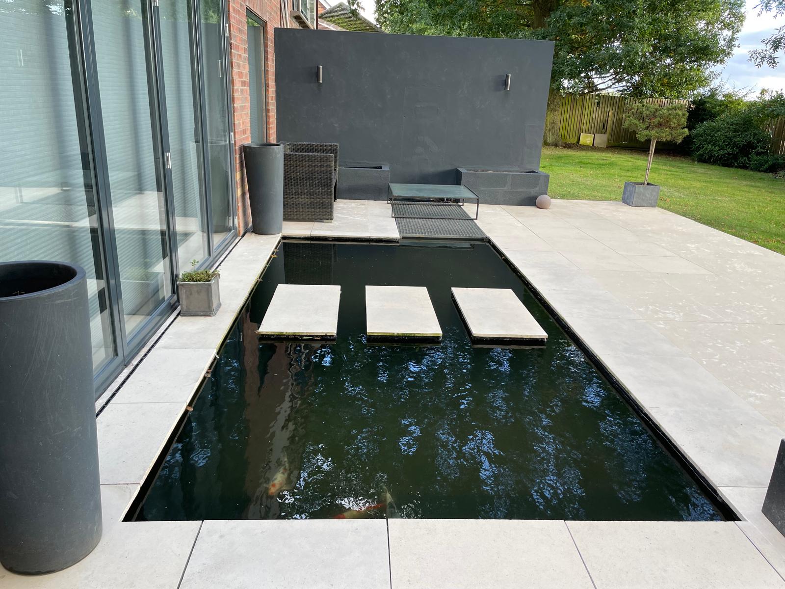 Contemporary koi pond wider view with terrace