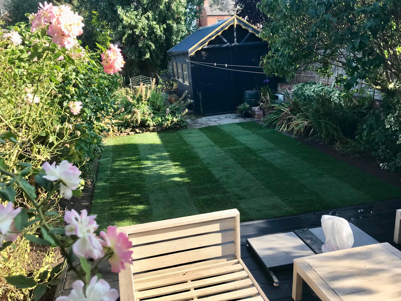 Completed garden with lawn, planting and dark garden studio