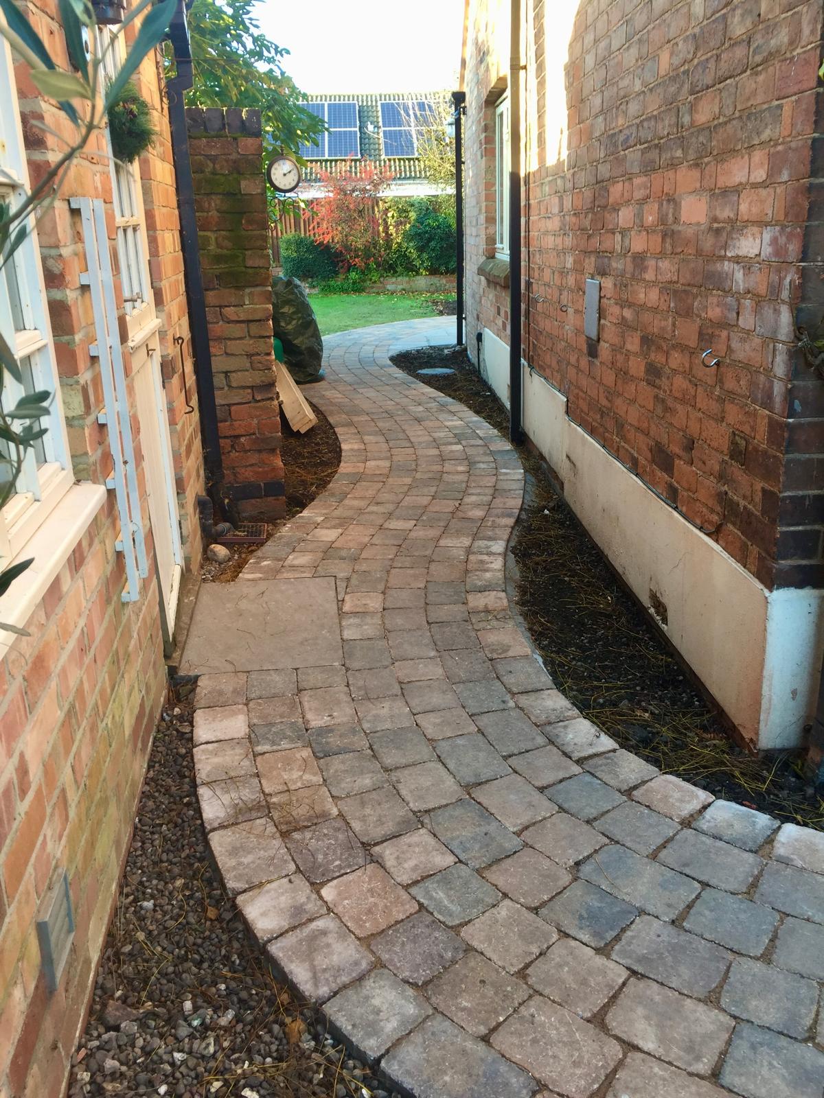 Curved cobble block paving through side alley