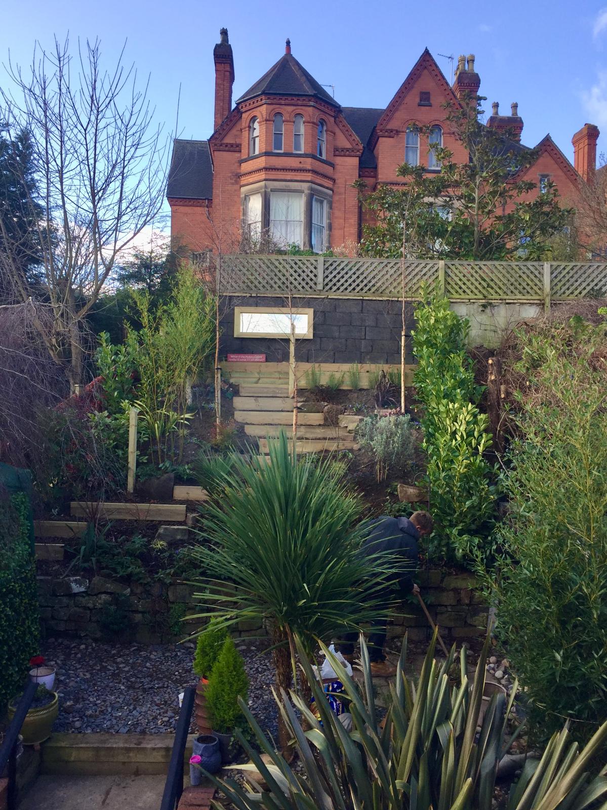Terraced garden with sleeper walls and architectural planting