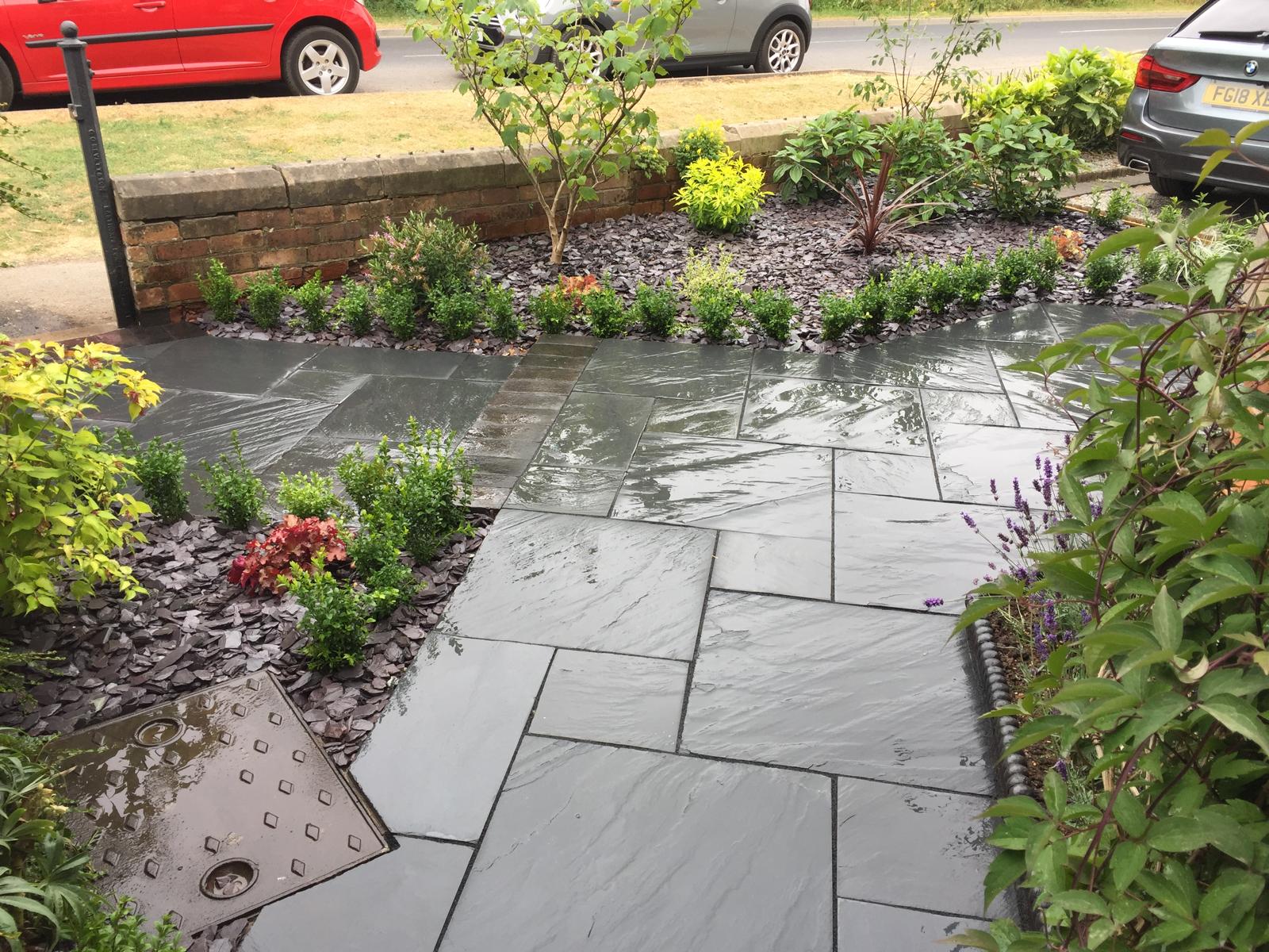 Overhead view of black slate paving with planting borders