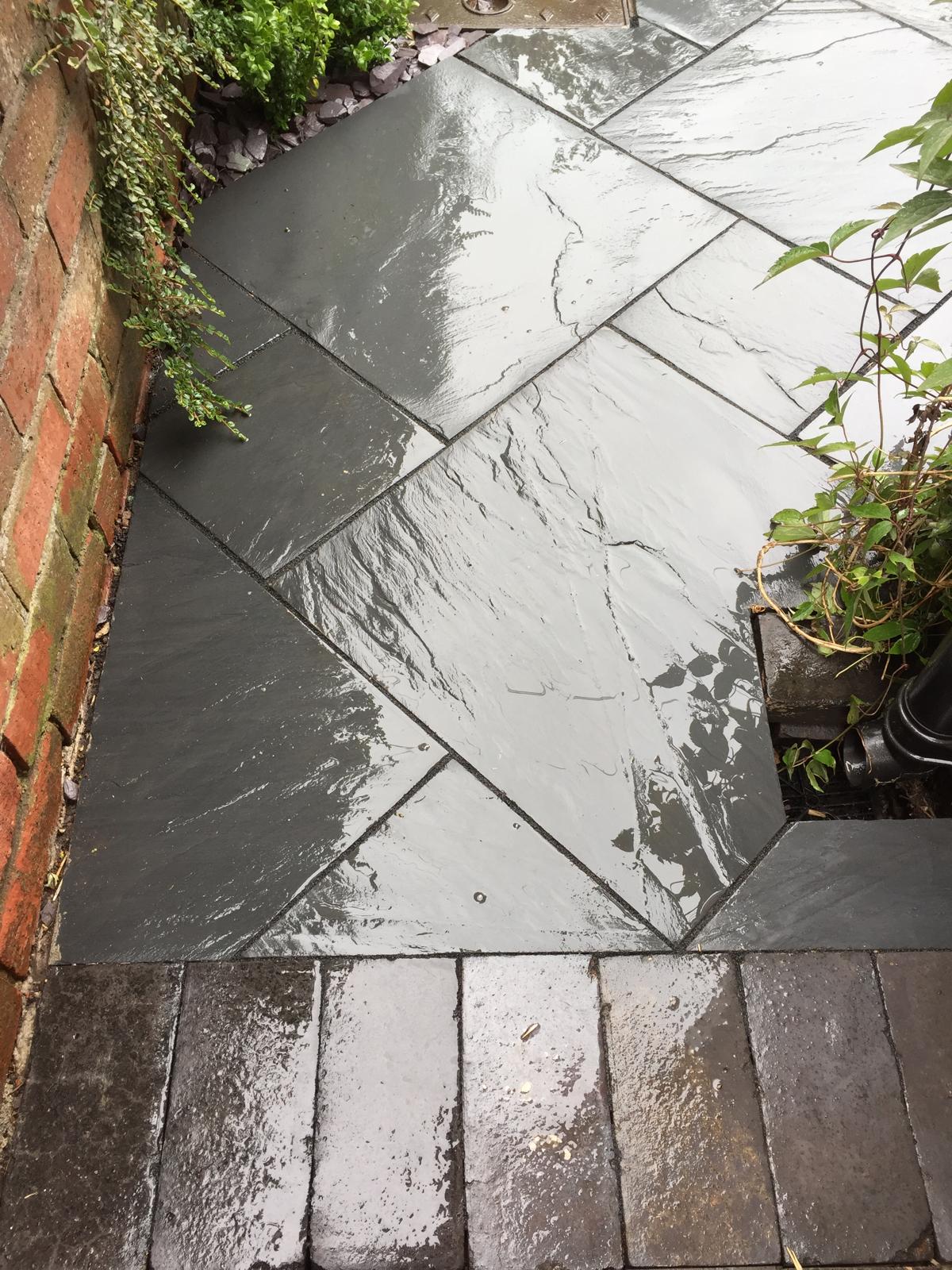 Close-up of diagonal black slate paving pattern
