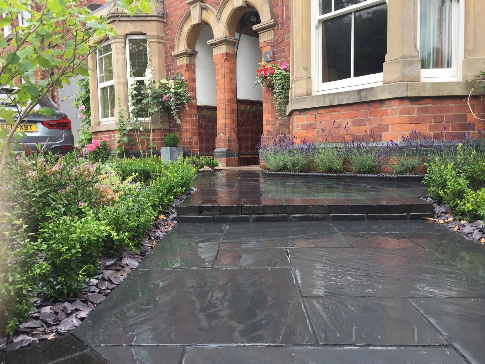 Grand front garden with black slate paving and lavender borders