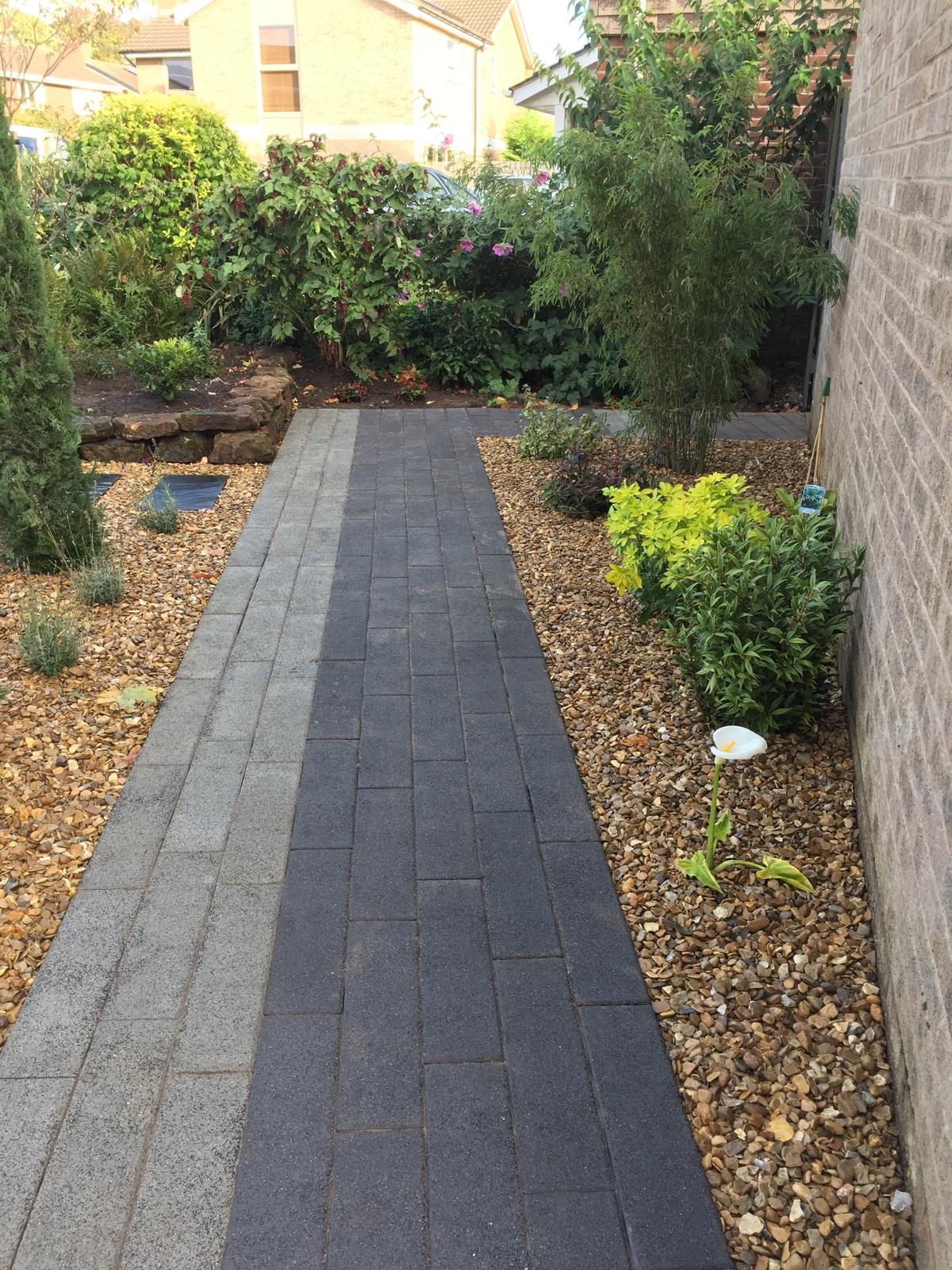 Block paving side path with gravel and shrub planting